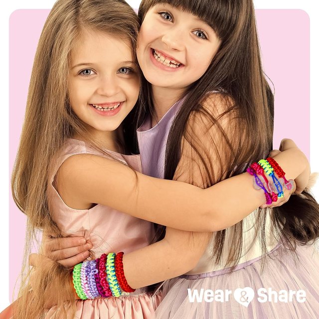 Two friends wearing friendship bracelets they made
